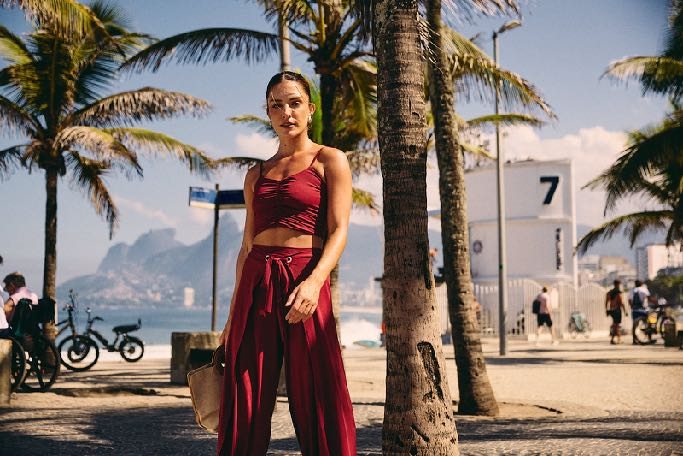 Modelo em look vermelho na orla do Rio